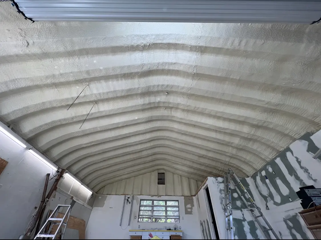 Spray polyurethane foam applied to the underside of a metal roof deck in Roselle